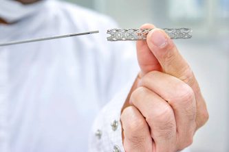 Man Holding Heart Stent In Hand